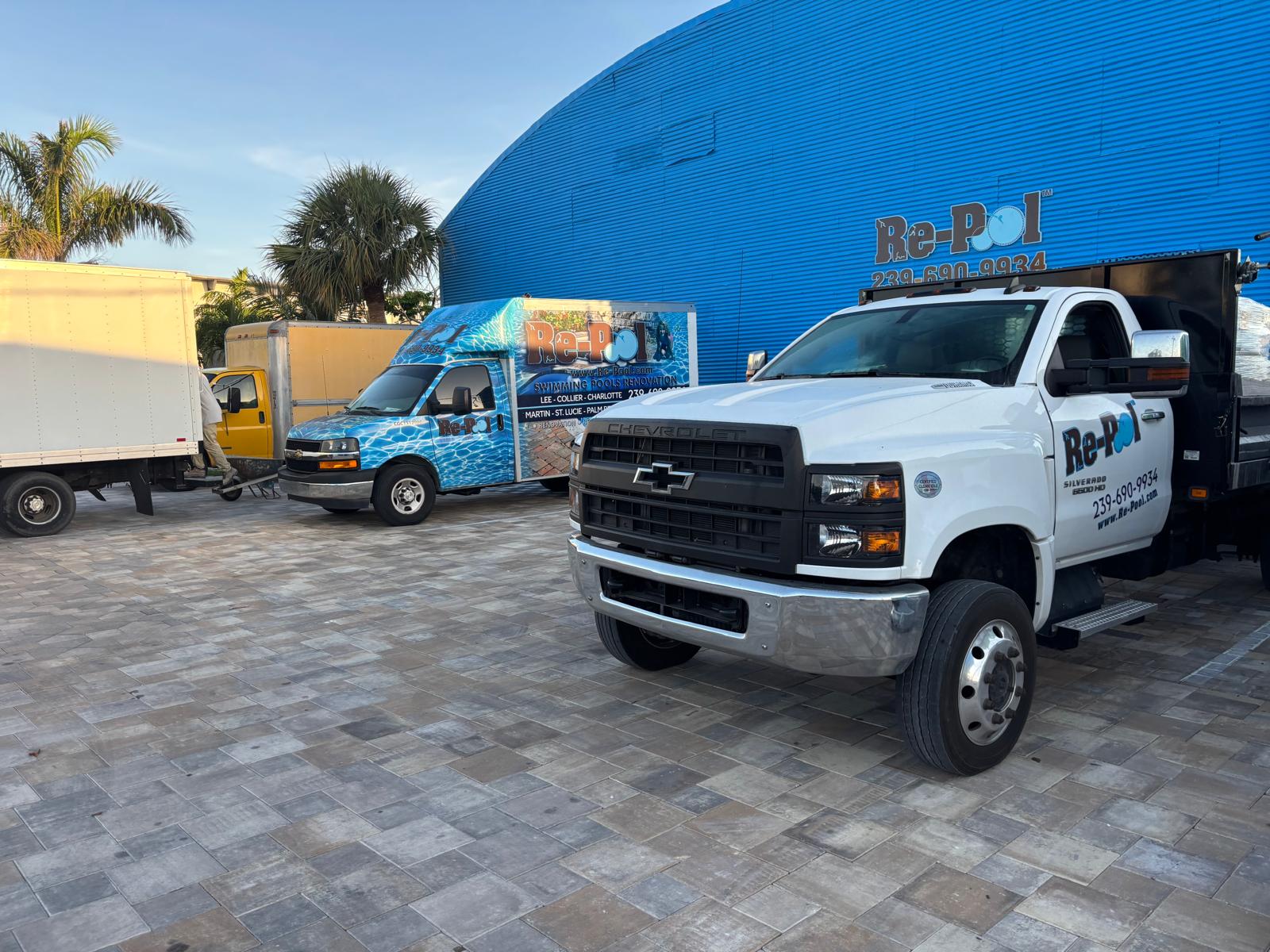 Re-Pool Chevrolet flatbed and branded box truck at the yard
